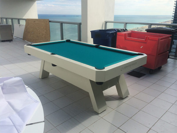 A pool table sitting on top of a tile floor.