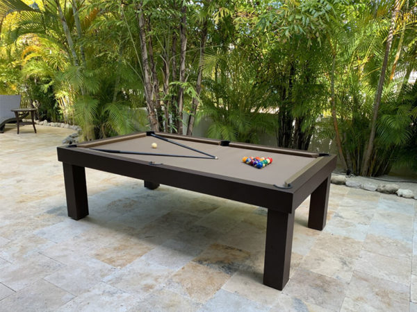 A pool table with balls and sticks on top of it.