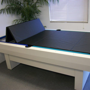 A pool table with a black cloth on top of it.