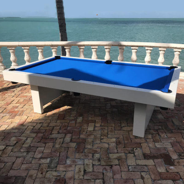 A pool table with blue cloth on top of it.