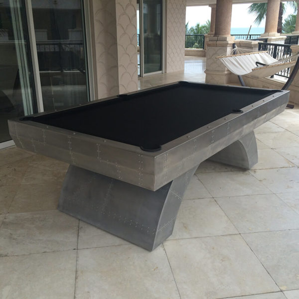 A pool table is sitting on the patio.