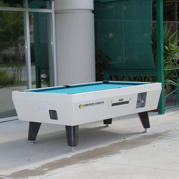 A pool table sitting on top of a cement floor.