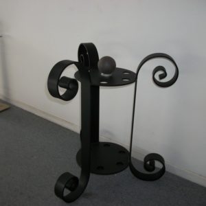 A black metal table with two wheels on it.