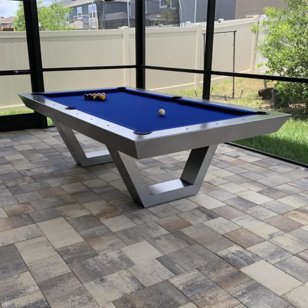 A pool table with blue cloth on top of it.