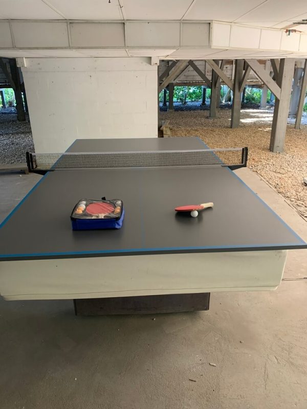 A table tennis table with a toy on top of it.