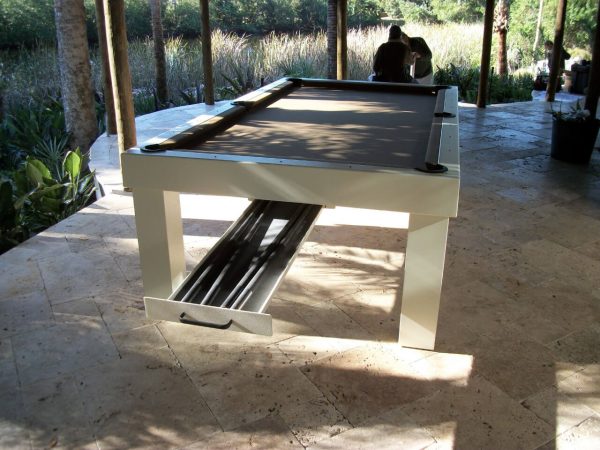 A pool table with a bench in the middle of it